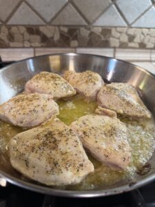 brown the seasoned chicken in butter and oil